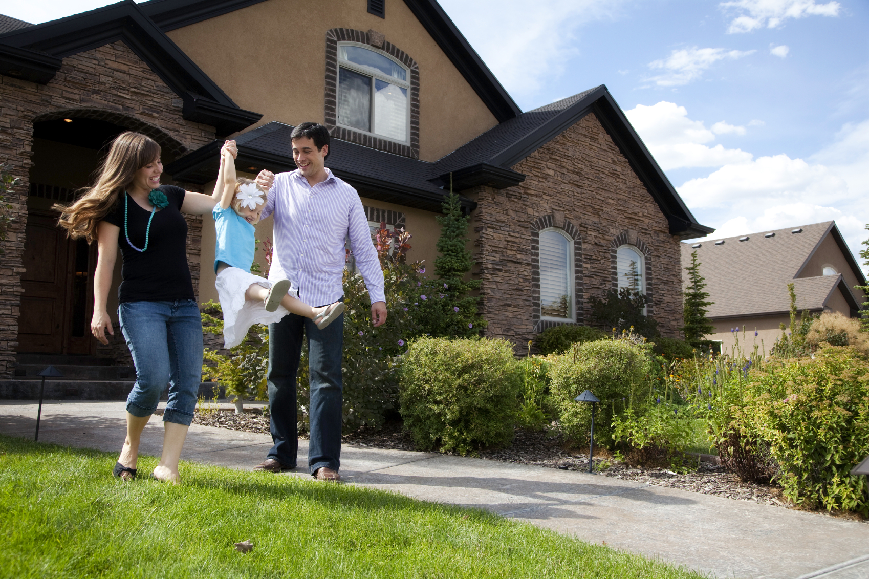 family in front of house